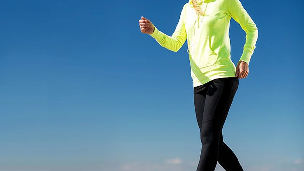 Close up on a plate of mashed potatoes, topped with baked pork chops with cream of mushroom soup, and a side of green beans.