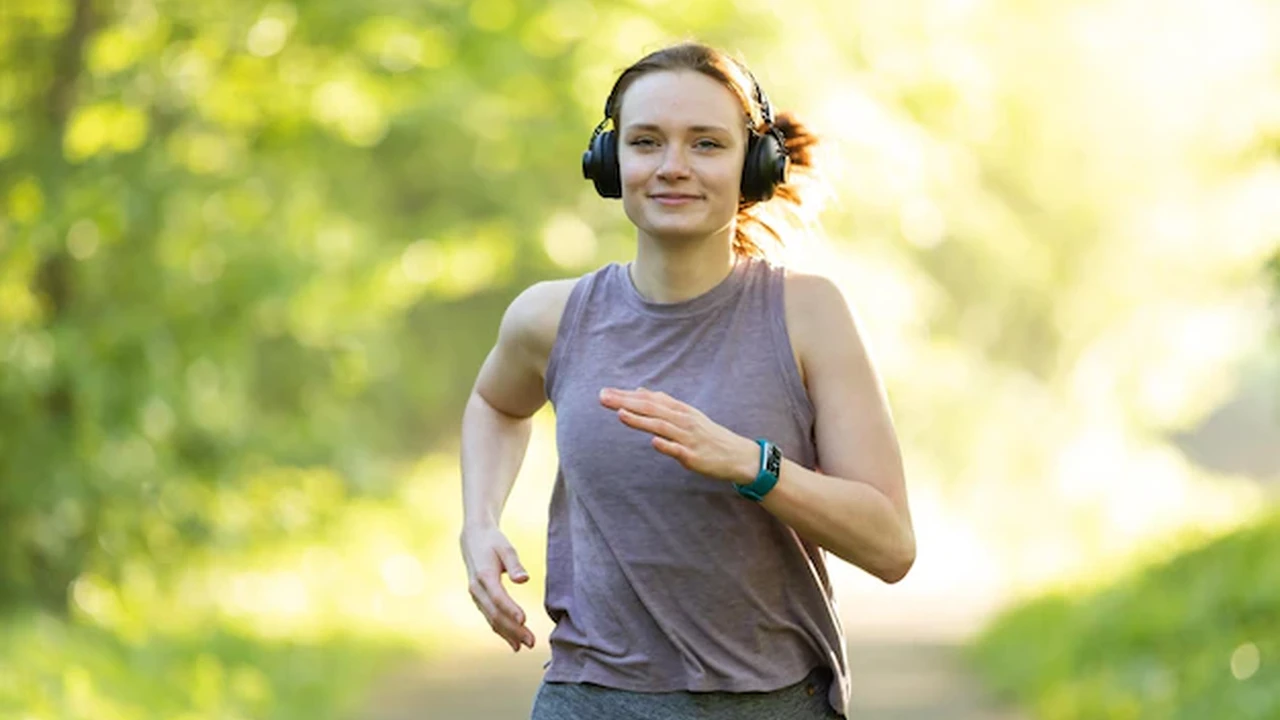 Close up on a plate of mashed potatoes, topped with baked pork chops with cream of mushroom soup, and a side of green beans.