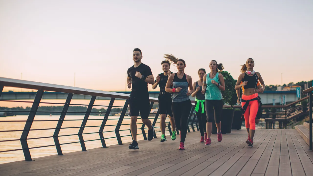 Close up on a plate of mashed potatoes, topped with baked pork chops with cream of mushroom soup, and a side of green beans.