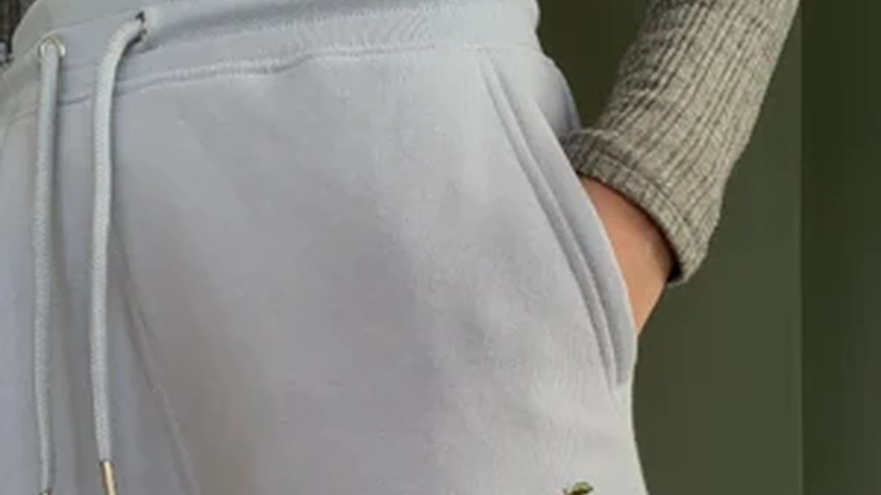 Close up on a plate of mashed potatoes, topped with baked pork chops with cream of mushroom soup, and a side of green beans.