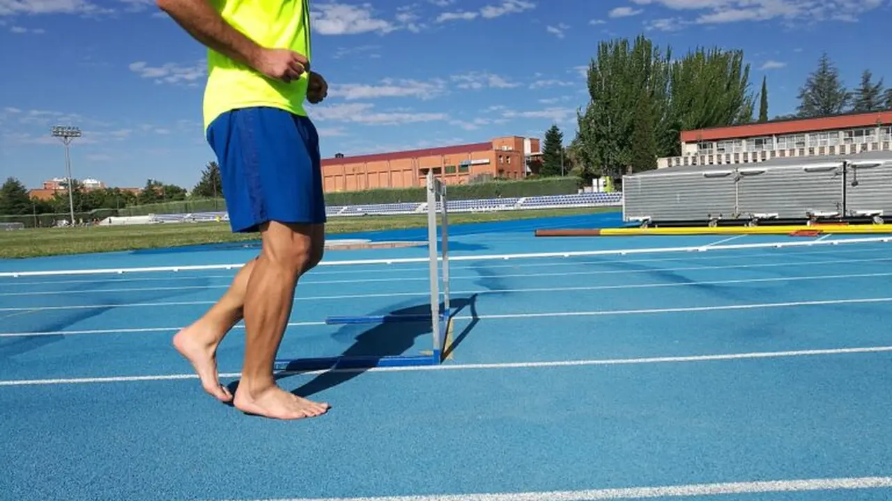 Close up on a plate of mashed potatoes, topped with baked pork chops with cream of mushroom soup, and a side of green beans.